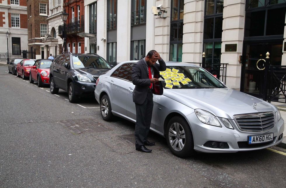 A car covered in parking tickets