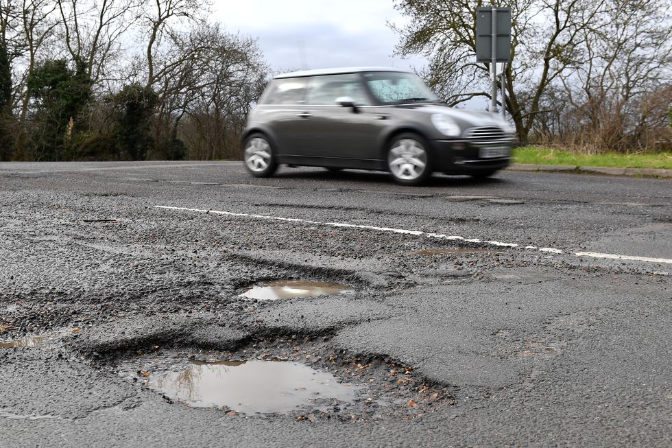 A car driving near a pothole