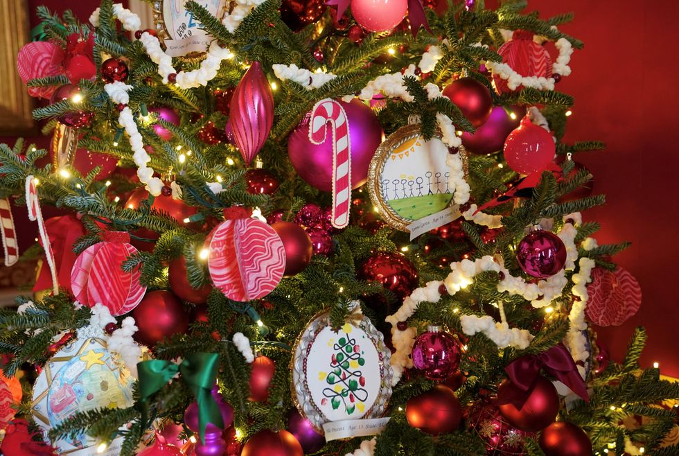 a christmas tree with tinsel, baubles and lights  