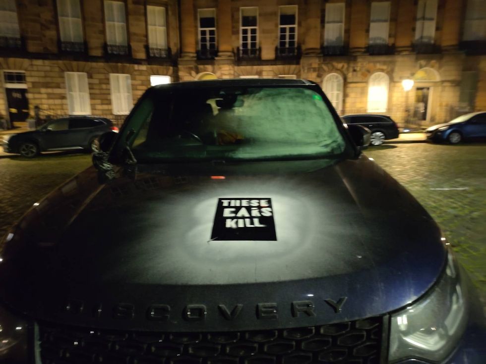 A defaced Land Rover Discovery with "these cars kill" sprayed on in Edinburgh