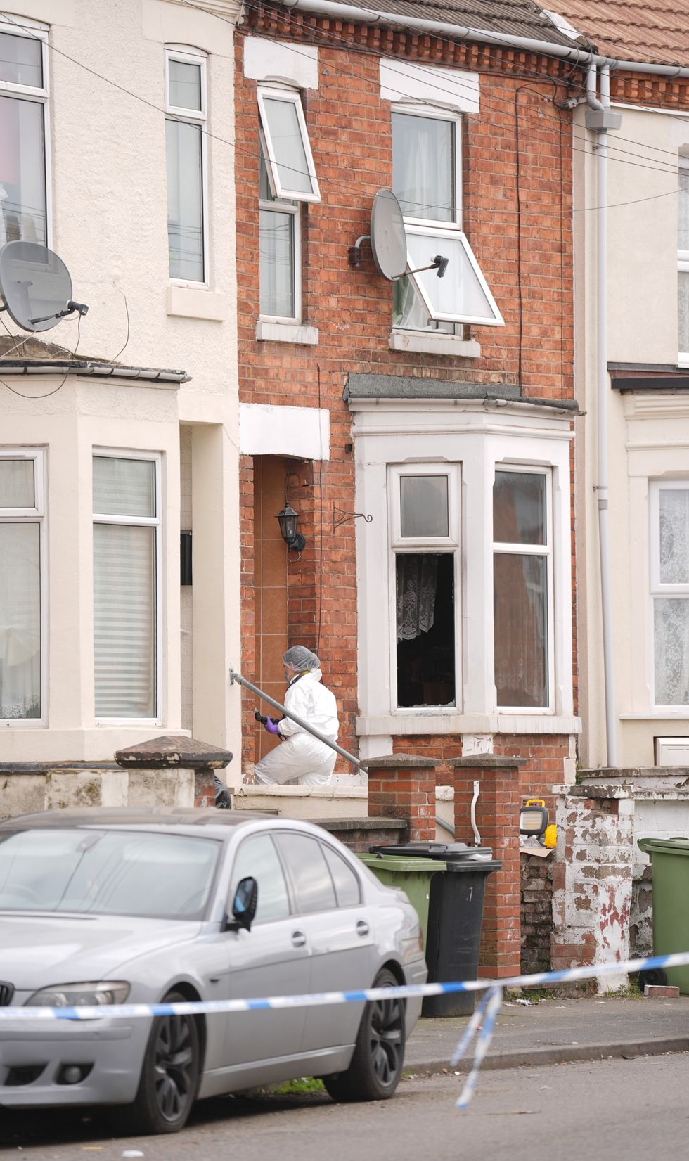 A forensics officer enters the house