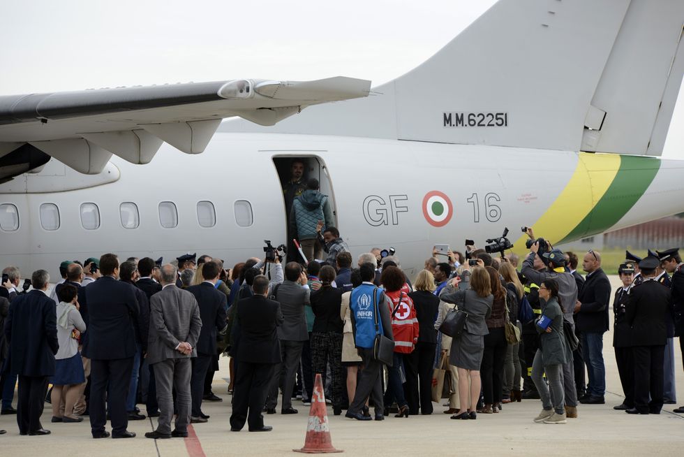 A group of migrants boarding a plane ready to fly to Sweden from Italy in 2015u200b