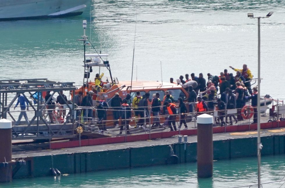 A group of people thought to be migrants are brought in to Dover, Kent