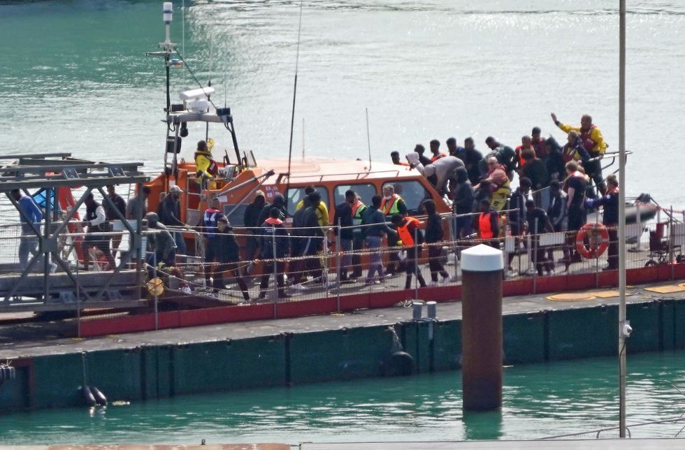 A group of people thought to be migrants are brought in to Dover, Kent