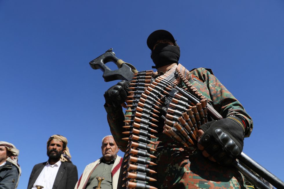 A Houthi policeman takes part in a protest against recent U.S.-led strikes on Houthi targets, near Sanaa, Yemen