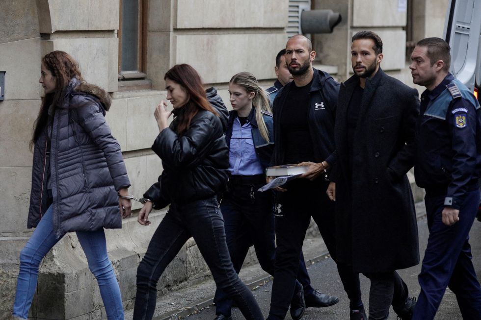 Andrew Tate pictured in HANDCUFFS as he arrives at court to fight human ...