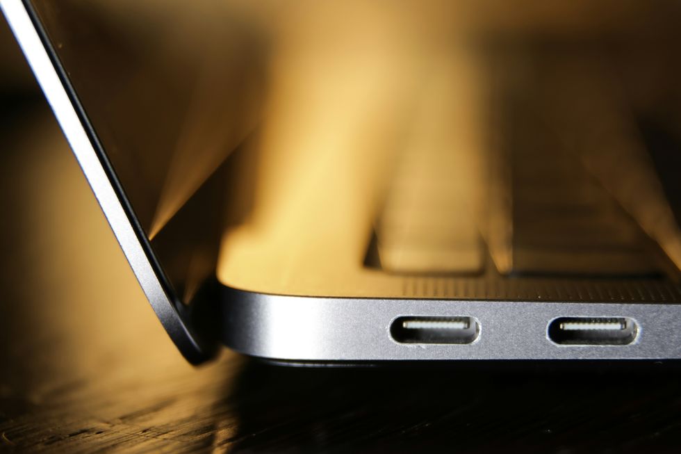 a macbook air pictured from the side showing off two usb-c ports side by side