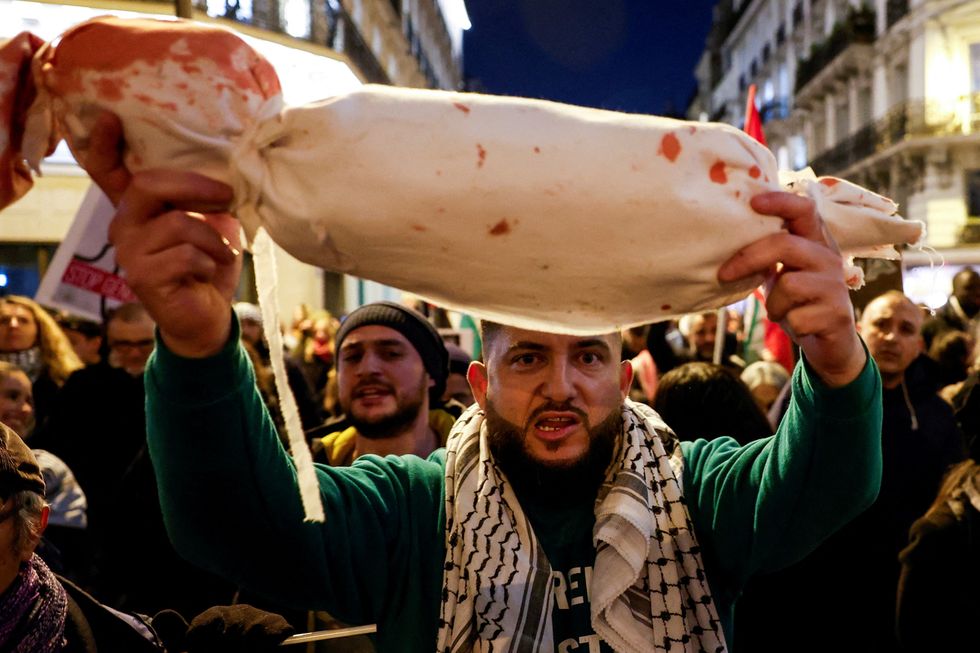 A man holds a mock body bag of a child during a demonstration in support of Palestinians\u200b