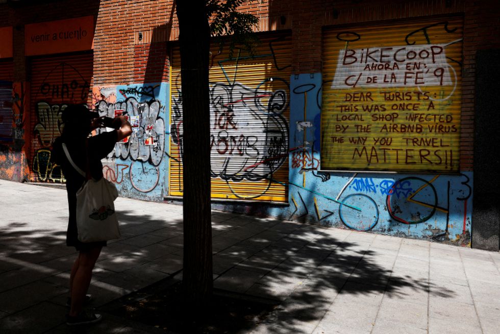 A message for tourists against Airbnbu2019s vacation rentals on the outside of a former local store in Madrid