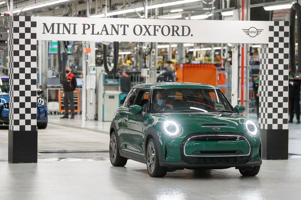 A Mini Cooper being driven by King Charles at the Mini Plant Oxford