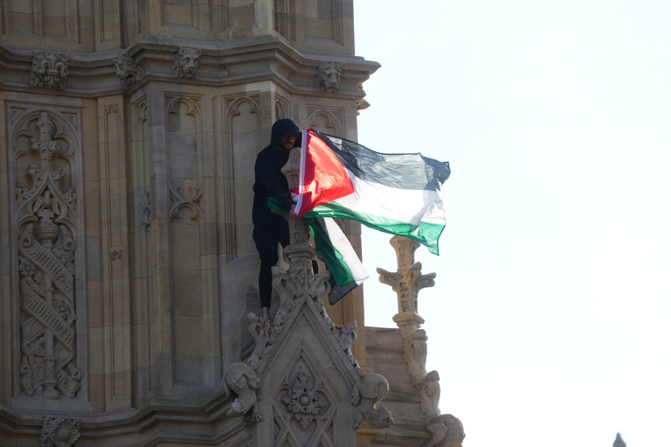 A Palestine flag was held over the tower