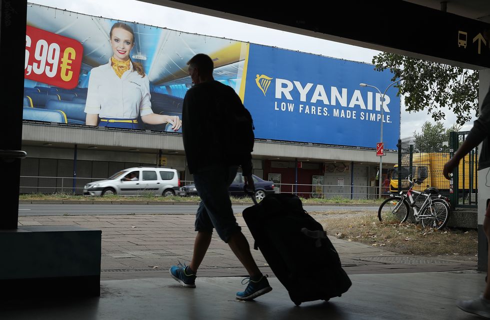 A passenger walking near a Ryanair sign