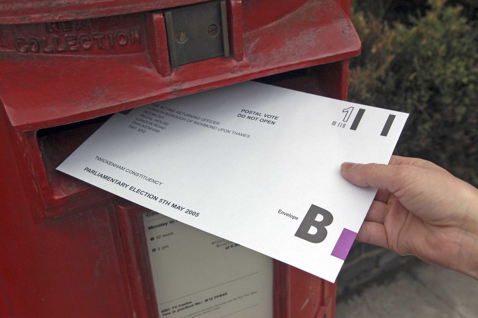 A person posts their postal vote