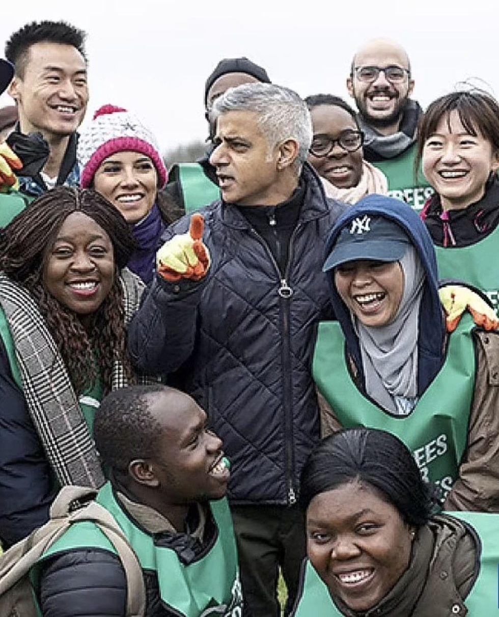 A photo of Khan surrounded by an ethnically diverse group of volunteers was deemed acceptable.