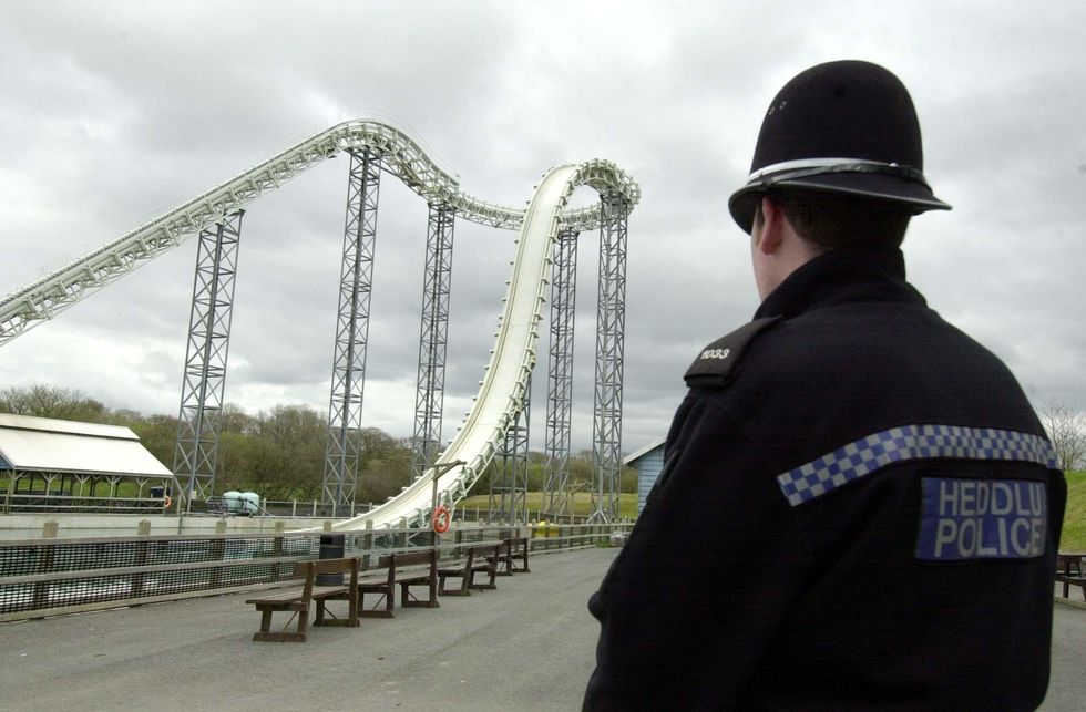 A police officer stands guard at the Hydro ride at Oakwood Leisure Park, in west Wales, where Hayley Williams, 16, of Pontypool, died yesterday after falling 100 feet from the top of the structure