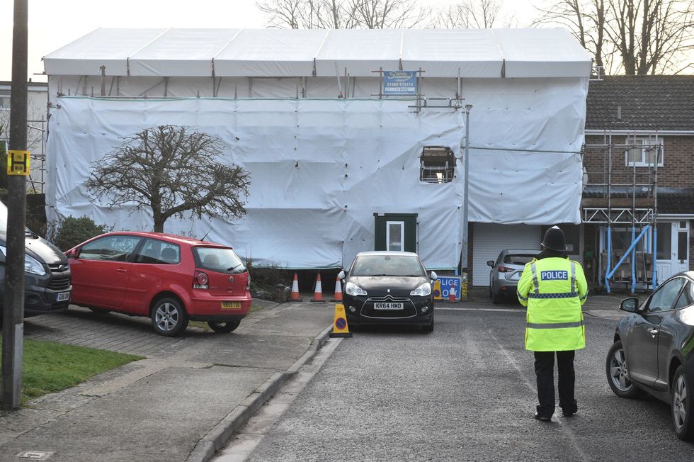 A police officer stands outside the home in Salisbury of Sergei Skripal