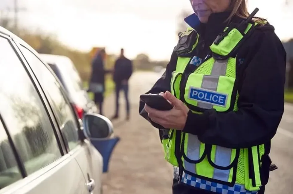 A police officer using a mobile phone