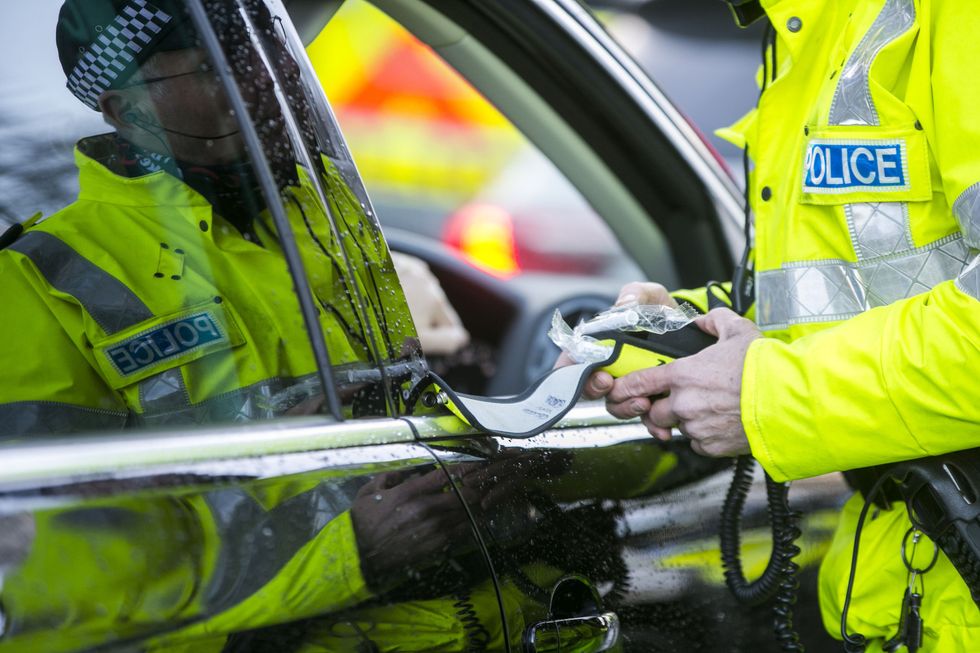 A police officer with a breathalyser