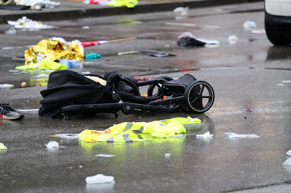 A pram lies on the road beside a car that drove into a crowdu200b in Munich