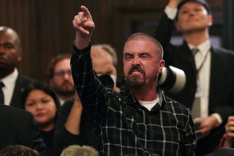 A protestor demanding a ceasefire in Gaza, gestures during U.S. President Joe Biden's speech at campaign even