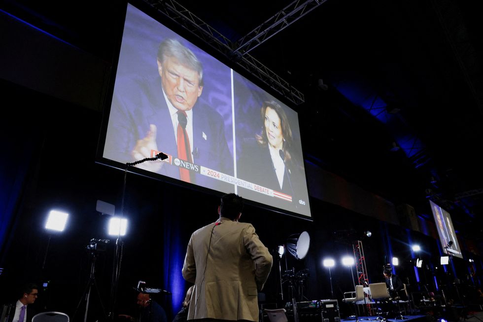 A screen displays the presidential debate