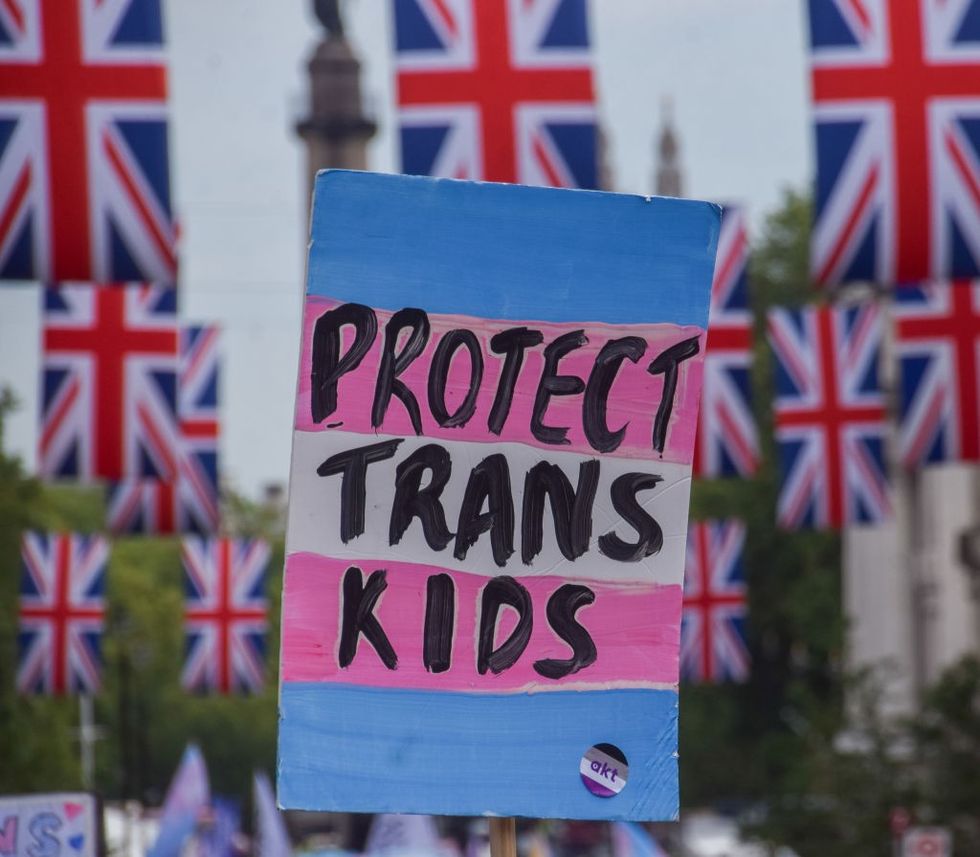 A sign saying "protect trans kids"