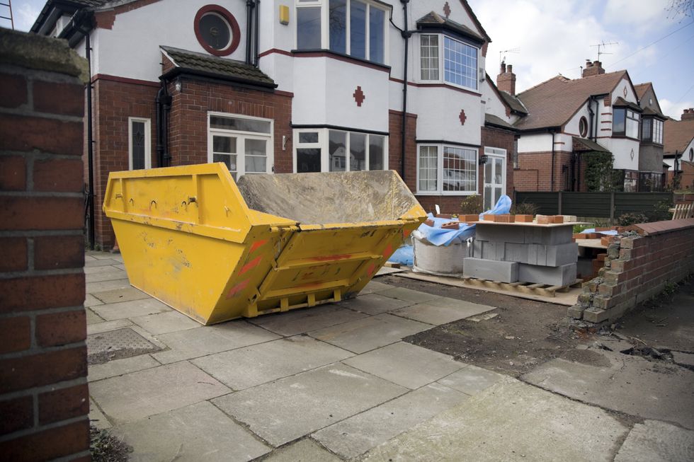 A skip situated outside a semi-detached house