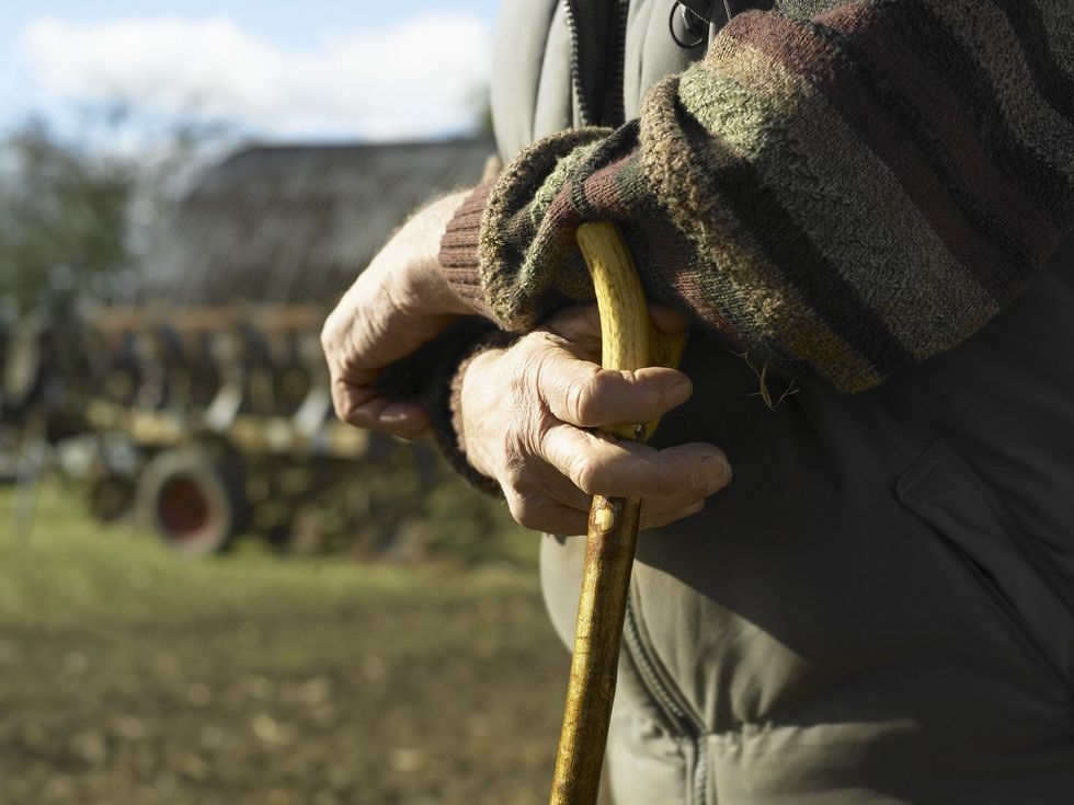 A stock image of a man with a walking stick