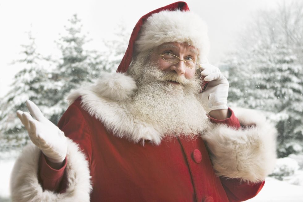 A stock image of Father Christmas on the phone