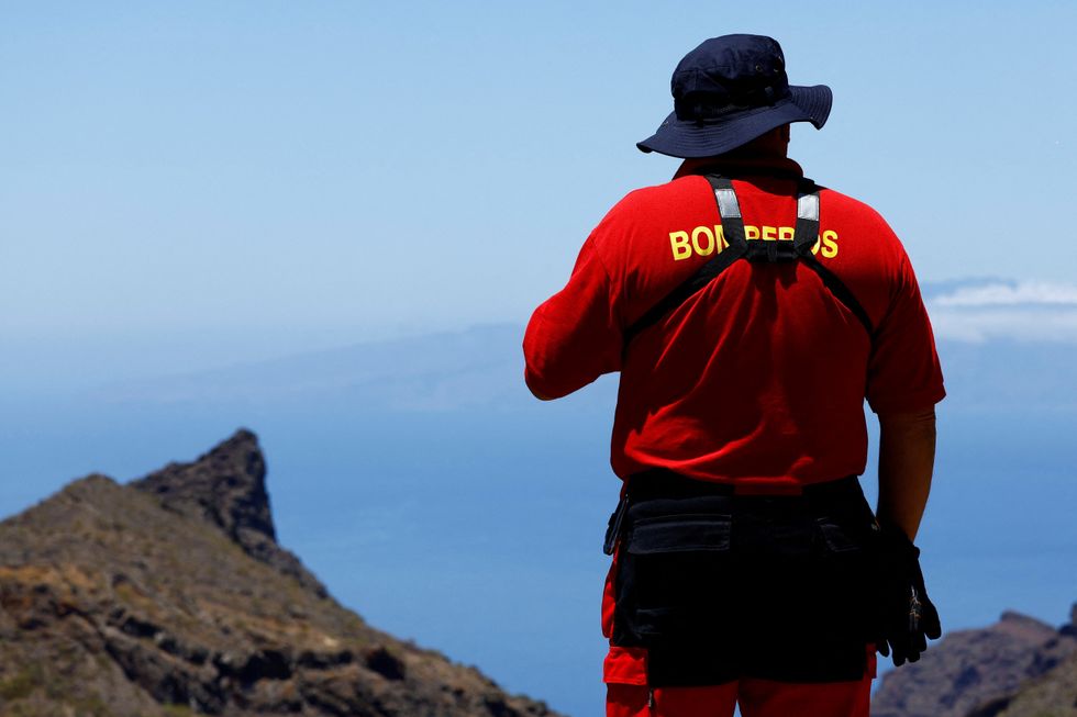 A volunteer firefighter searches for the young Briton Jay Slater in the Juan Lopez ravine near Masca