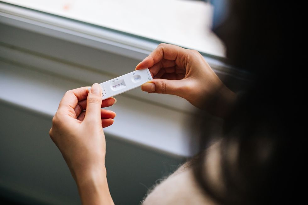 A woman holds a Covid test