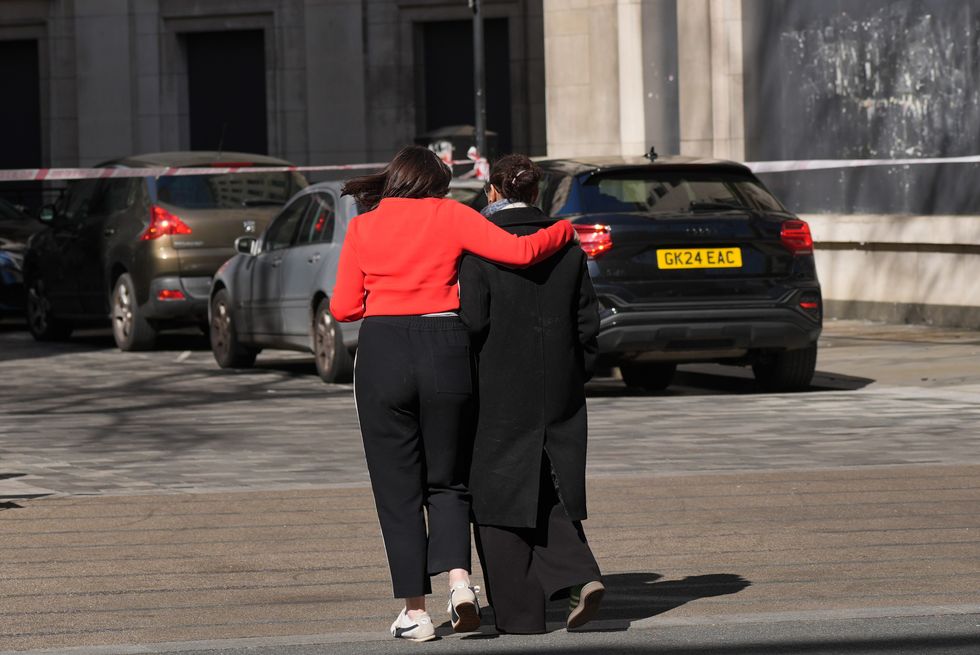 A woman is comforted at the scene of an incident involving a van in The Strand