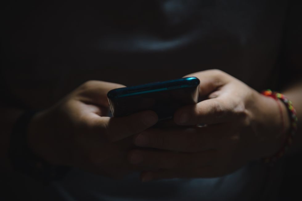 An image of a man using his phone