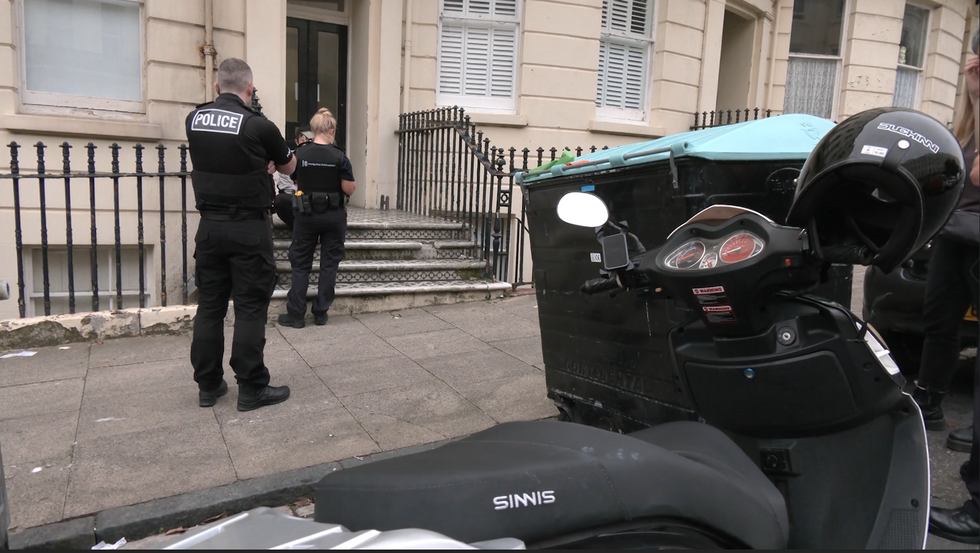 An image of a police officer and immigration officer addressing an undocumented food delivery worker