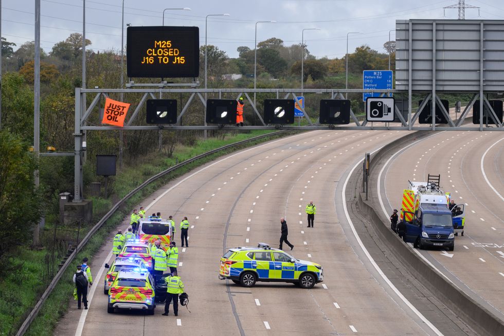 An image of police officers gathering to halt the M25 protesters