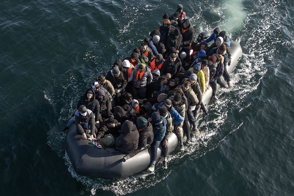 An inflatable dinghy carrying around 65 migrants crosses the English Channel