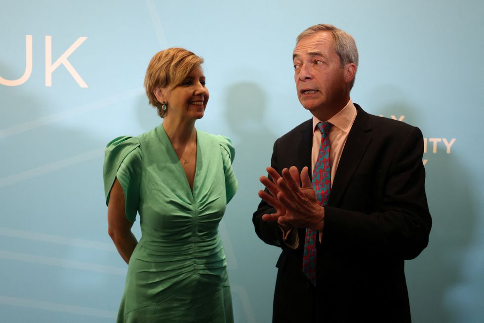 Andrea Jenkyns stands next to Britain's Reform UK party leader Nigel Farage during a campaign event,