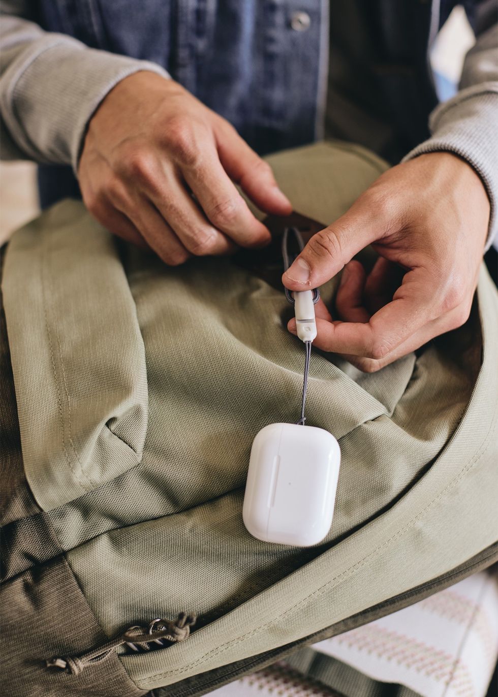 apple airpods pro with lanyard attached to someones bag