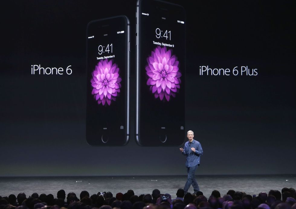 Apple CEO Tim Cook pictured on stage talking about the iPhone 6 and iPhone 6 Plus