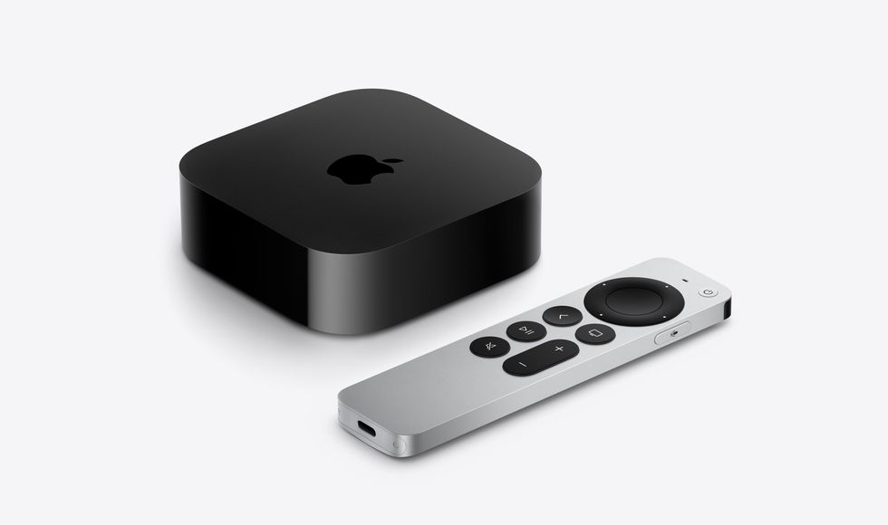 apple tv box pictured on a white background with the siri remote lying on its side