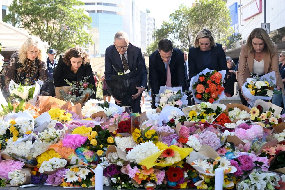 Australian Prime Minister Anthony Albanese and New South Wales Premier Chris Minns join other politicians as they lay flowers at the scene of Saturday's mass stabbing at Bondi Junction