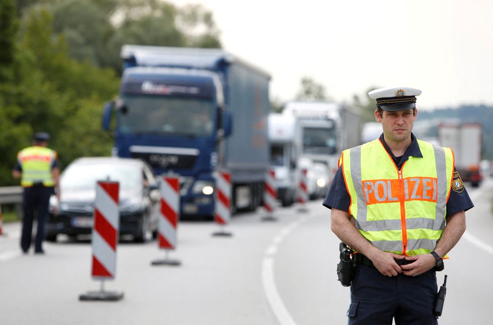 Bavarian Police Officers control cars at a temporarily checkpoint on the motorway between the Austrian and German border