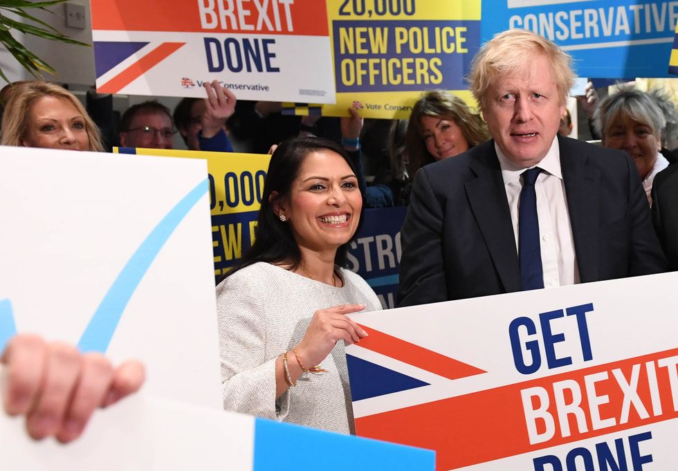 Boris Johnson and  Priti Patel during a members rally held