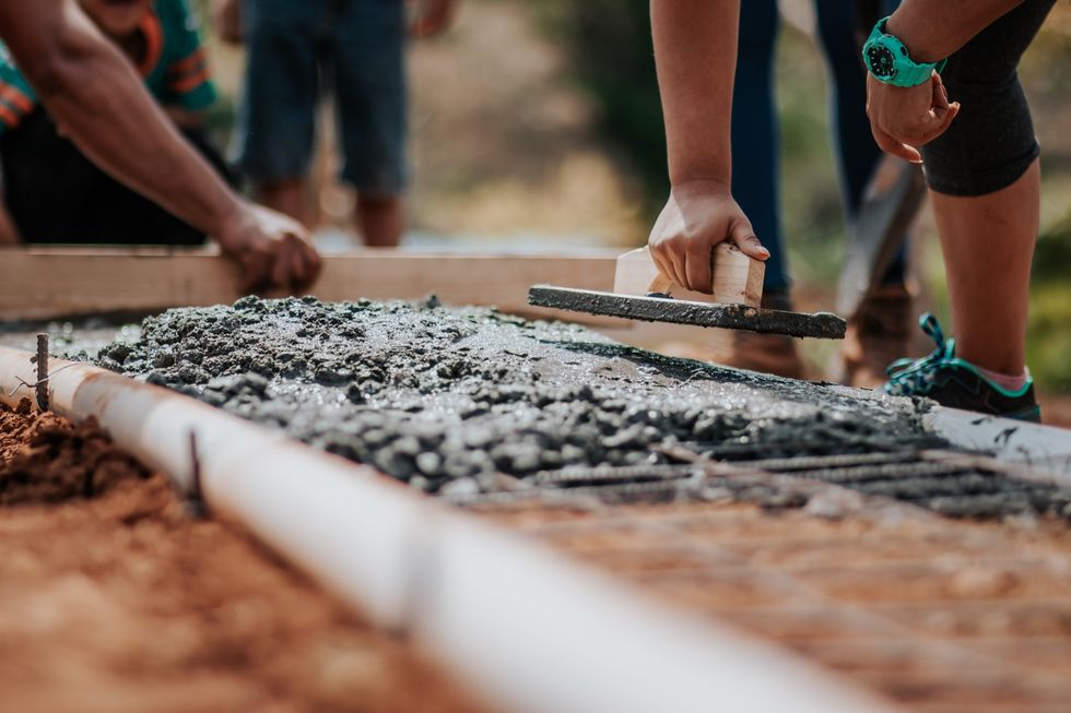 Builders laying concrete