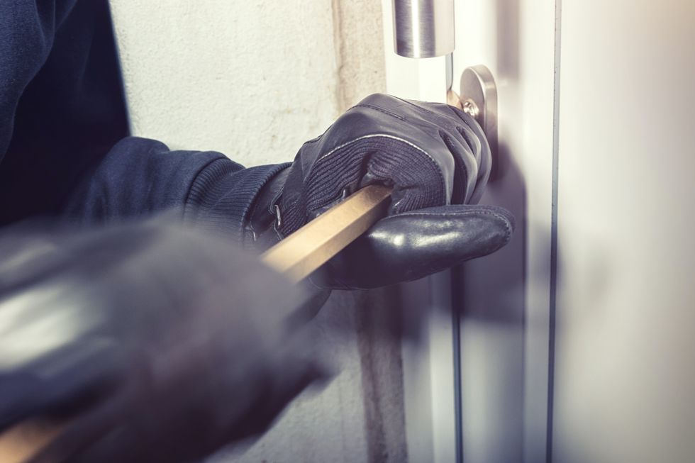 Burglar breaking into house