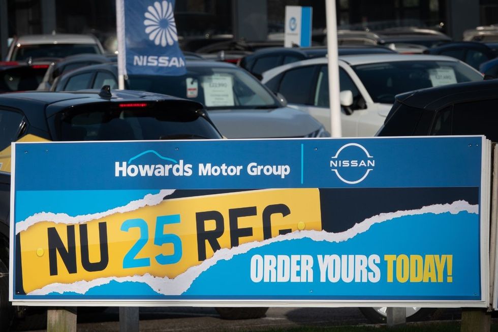 Car sales forecourt with a new number plate sign