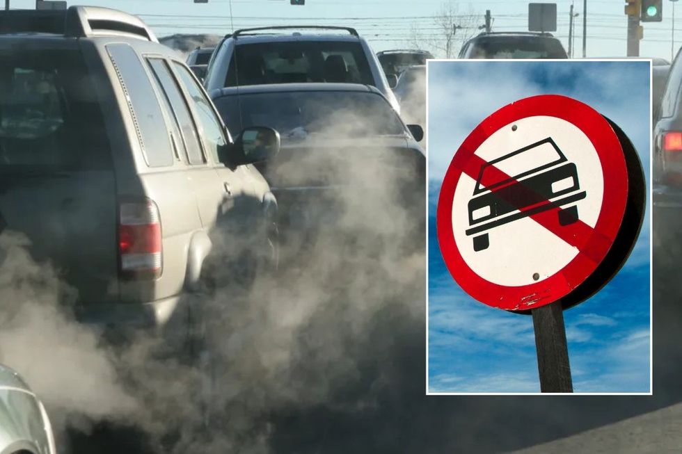 Car traffic with exhaust smoke and a car ban sign