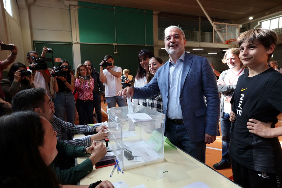 Catalan Socialist party (PSC) candidate for Mayor of Barcelona Jaume Collboni (L) flanked by his nephew casts his ballot in Barcelona on May 28, 2023