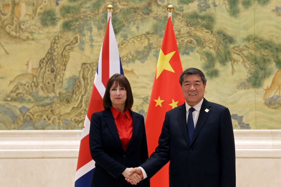 Chinese Vice Premier He Lifeng and Britain's Chancellor of the Exchequer Rachel Reeves shake hands