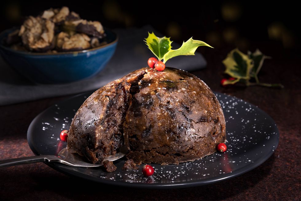 Christmas pudding on a plate in the foreground